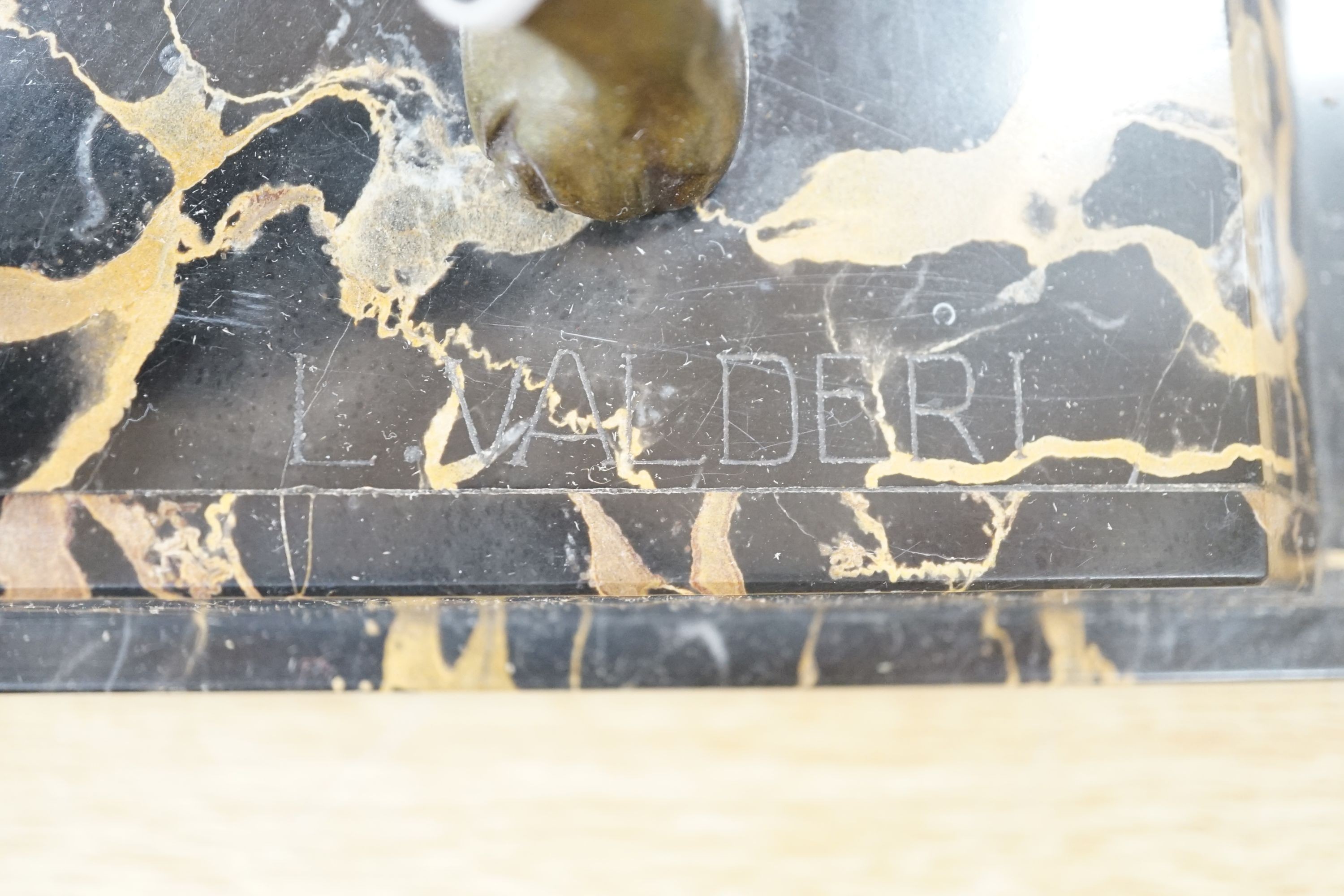 An Art Deco bronzed metal and marble running man with greyhounds, signed L Valderi, 85cm long